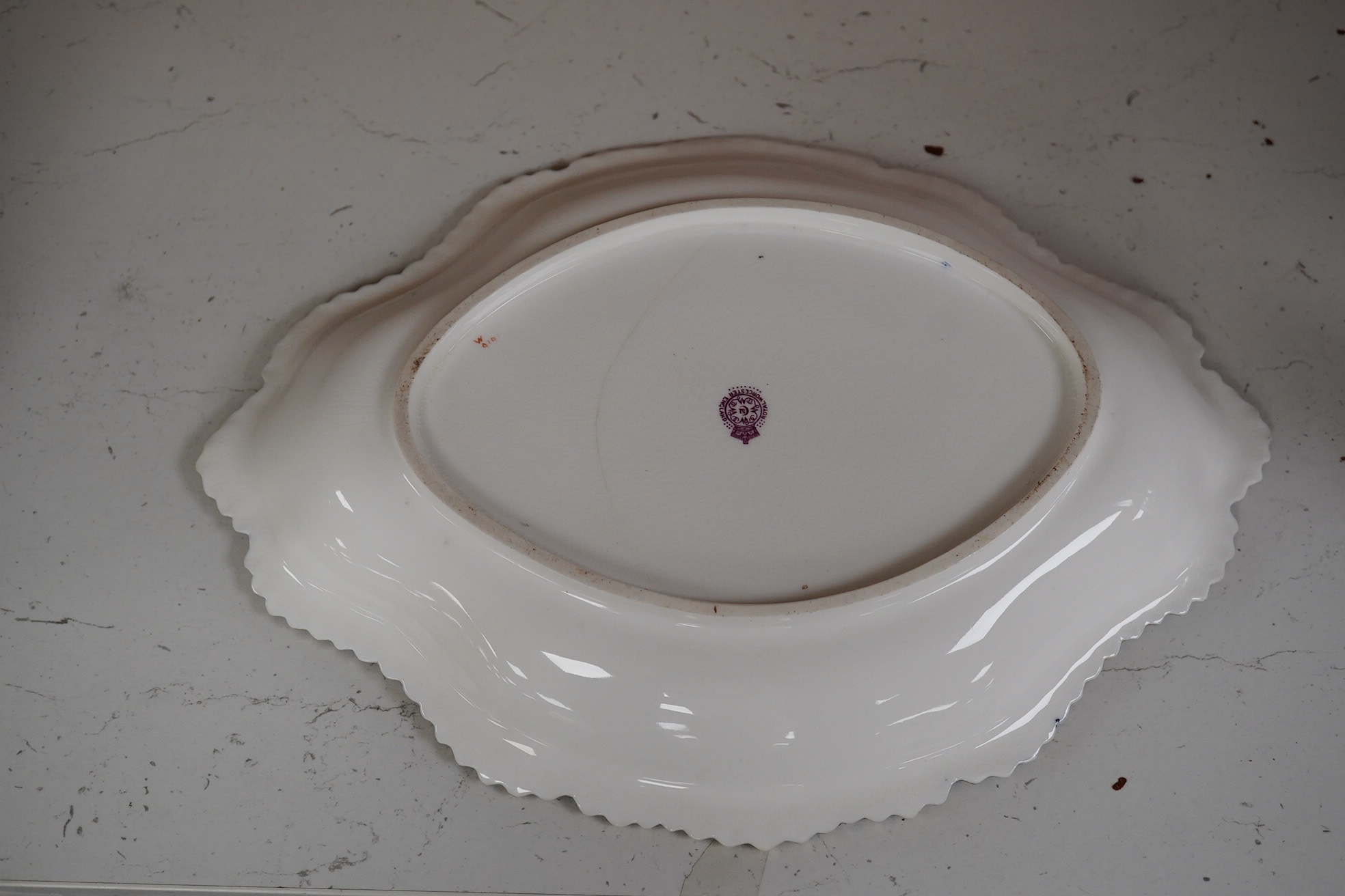 A Royal Worcester fruit painted oval dessert dish, signed Cole. 30.5cm wide. Condition - crack to base